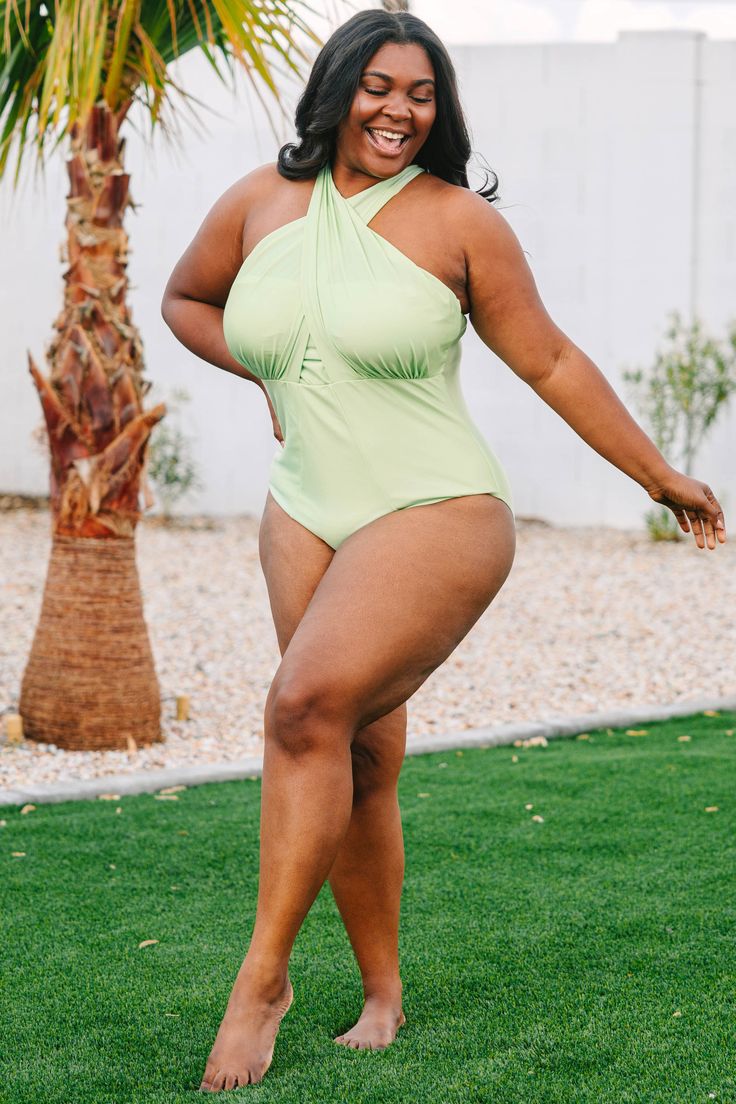 This swimsuit is perfect for your next beach trip! This swimsuit has a fierce shimmery green color that's perfect for the season! It has a classic one-piece fit, features a tied crisis cross halter neckline bust! Wear this swimsuit to every pool party on your calendar this Summer! 82% Polyamide, 18% Elastane Solid Color Cross-tied Swimwear For Summer, Cross-tied Halter Neck Swimwear For Beach Season, Crisscross Strap Halter Top For Beach Season Pool, Cross-tied Swimwear For Swimming, Crisscross Straps Halter Top For Beach Season, Halter Top With Crisscross Straps For Beach Season, Green Tankini For Beach Party, Solid Cross-tied Swimwear For Poolside, Solid Color Cross-tied Swimwear For Poolside