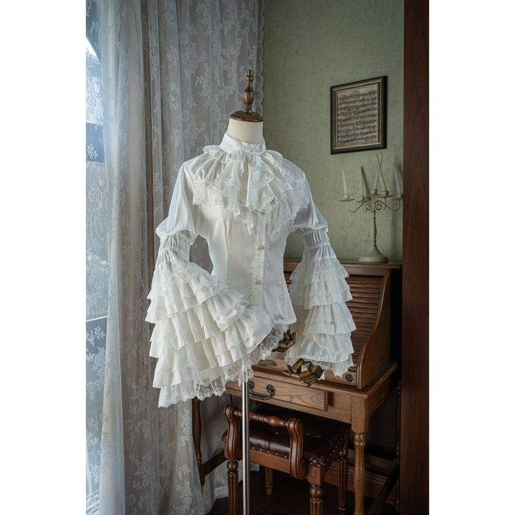 A Victorian blouse with a noble and elegant queen-like feel. Her chest is decorated with large jabots, and her lace embroidery and ruffles are generously decorated. Her sleeves have an overwhelming presence. Now, let's go to the ball tonight. 
 
 

 

 
 
 What is included in your order 
 
 Blouse 
 
 
 
 Item 
 
 Ver1 
 
 
 
 Ver2 
 
 
 
 Size 
 
 XS size 
 
 Length: 63cm 
 Bust: 86cm 
 Waist: 74cm 
 
 S size 
 
 Length: 64cm 
 Bust: 90cm 
 Waist: 78cm 
 
 M size 
 
 Length: 65cm 
 Bust: 94cm Victorian Blouse, White Queen, Lace Embroidery, Pure White, Ruffles, Queen, White, Lace, Pure Products