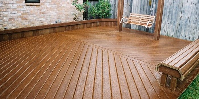 a wooden deck with a bench next to it