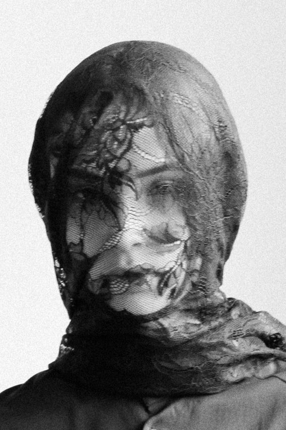 black and white photograph of a woman's face covered in lace