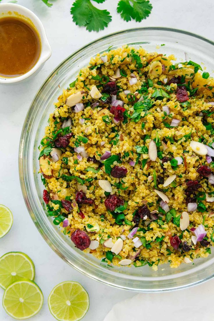 a glass bowl filled with rice and garnished with cilantro