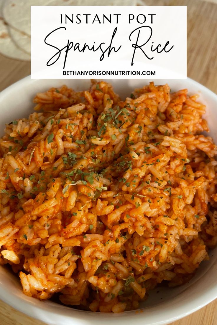 instant pot spanish rice in a white bowl on a wooden table with text overlay that reads instant pot spanish rice