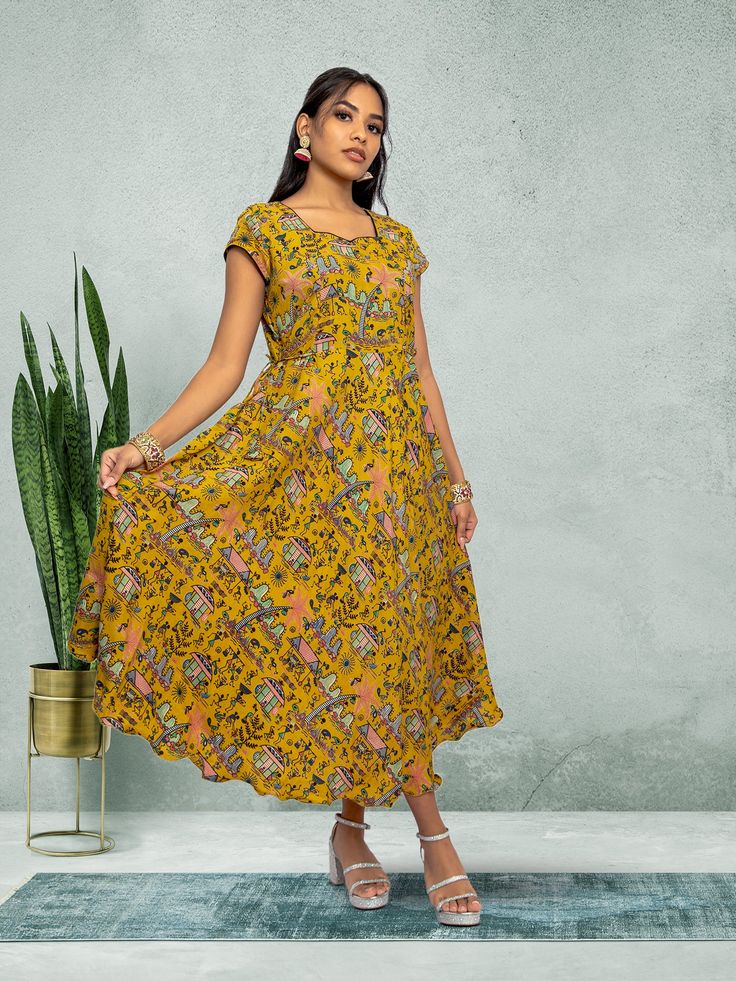 Embrace elegance with our Tranquil Threads yellow knee-length dress. Featuring a stunning print, this dress is perfect for everyday wear or a night out in the city. Crafted with care for the modern woman who values both comfort and style. Key Specifications : Material Kalankari Silk Occasion Casual Type Fusion/Indowestern Knee-length Printed Sundress, Casual Midi Dress With Vibrant Print, Printed Knee-length Sundress, Yellow Dresses With Printed Motifs For Festive Season, Yellow Dresses With Printed Motifs For Festive Occasions, Yellow Knee-length Floral Dress, Yellow Dress With Printed Motifs For Festive Occasions, Festive Floral Print Beach Dresses, Festive Yellow Maxi Length Dress