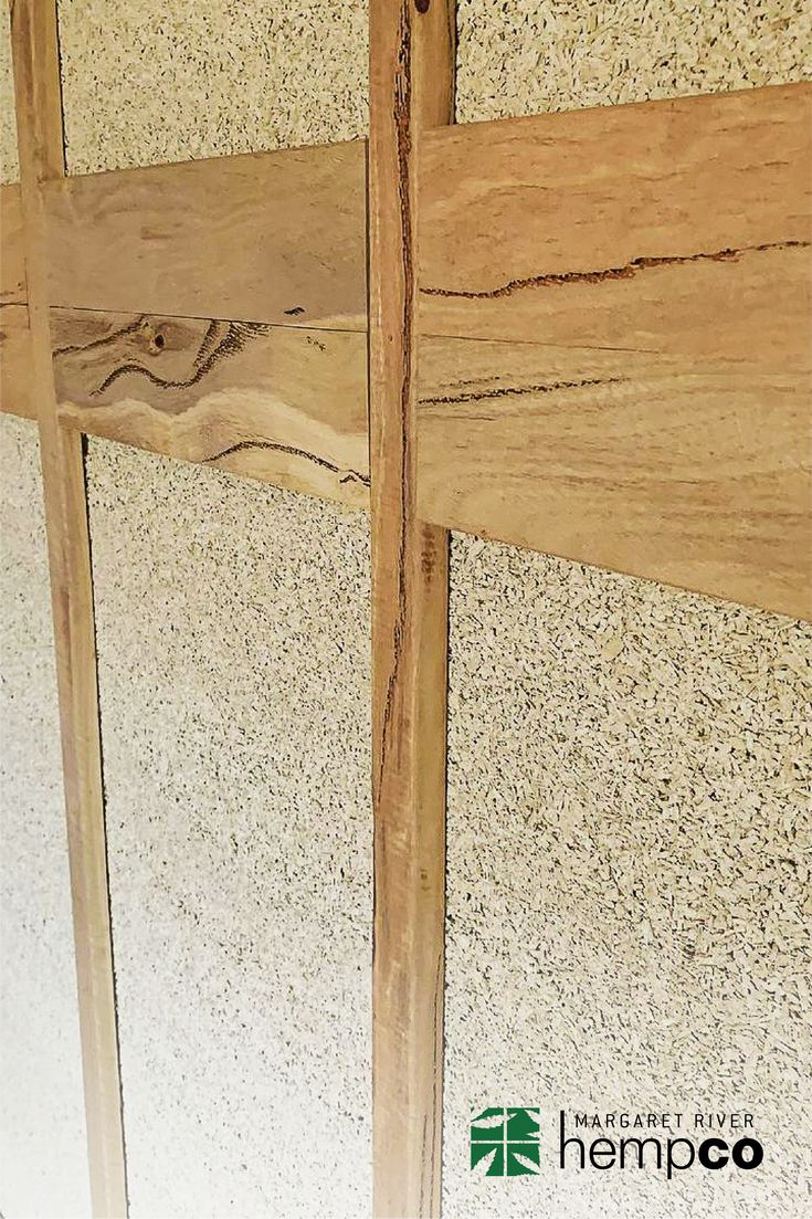 a close up view of the side of a wall with wood planks on it