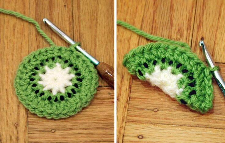 crocheted green and white object on wooden table next to yarn with two knitting needles