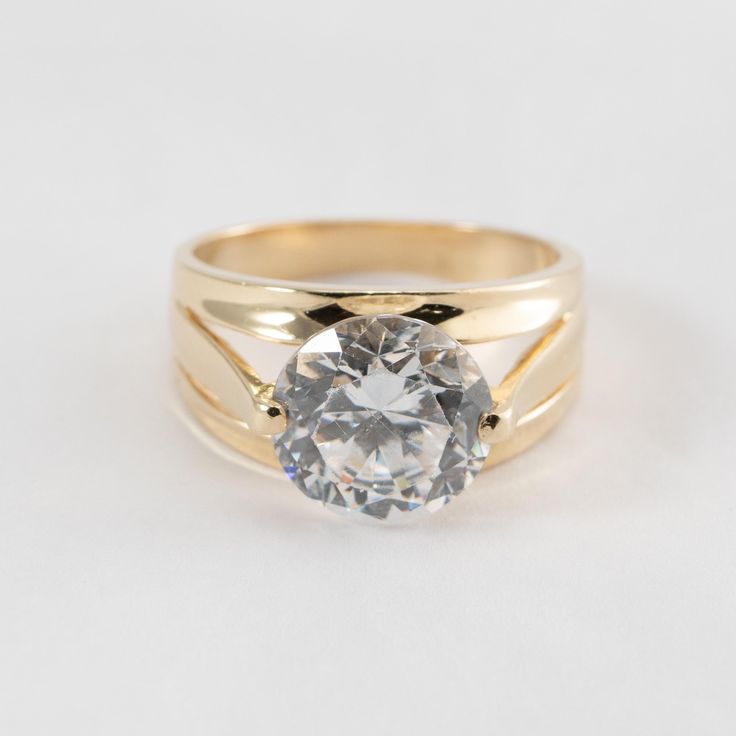 Hi. This is a very pretty CZ stone ring in 14k yellow gold. It is marked 14k on the inside of the ring. The stone is CZ, Cubic Zirconia and measures 10mm in diameter. The ring finger size is 6. Sorry, we do not resize rings. The weight of the ring is 5.2 grams. This will have insurance and signature confirmation. Thanks for looking. Yellow Gold Wide Band Promise Ring With Vs Clarity, Gold Wide Band Ring With Brilliant Cut For Promise, Gold Wide Band Ring With Vvs Clarity, Classic Gold Crystal Ring With Round Cut, Classic Gold Topaz Promise Ring, Round Brilliant Cut Wide Band Wedding Ring, Gold Wide Band Ring With Brilliant Cut, Classic Gold Cubic Zirconia Birthstone Ring, Classic Gold Birthstone Ring With Cubic Zirconia