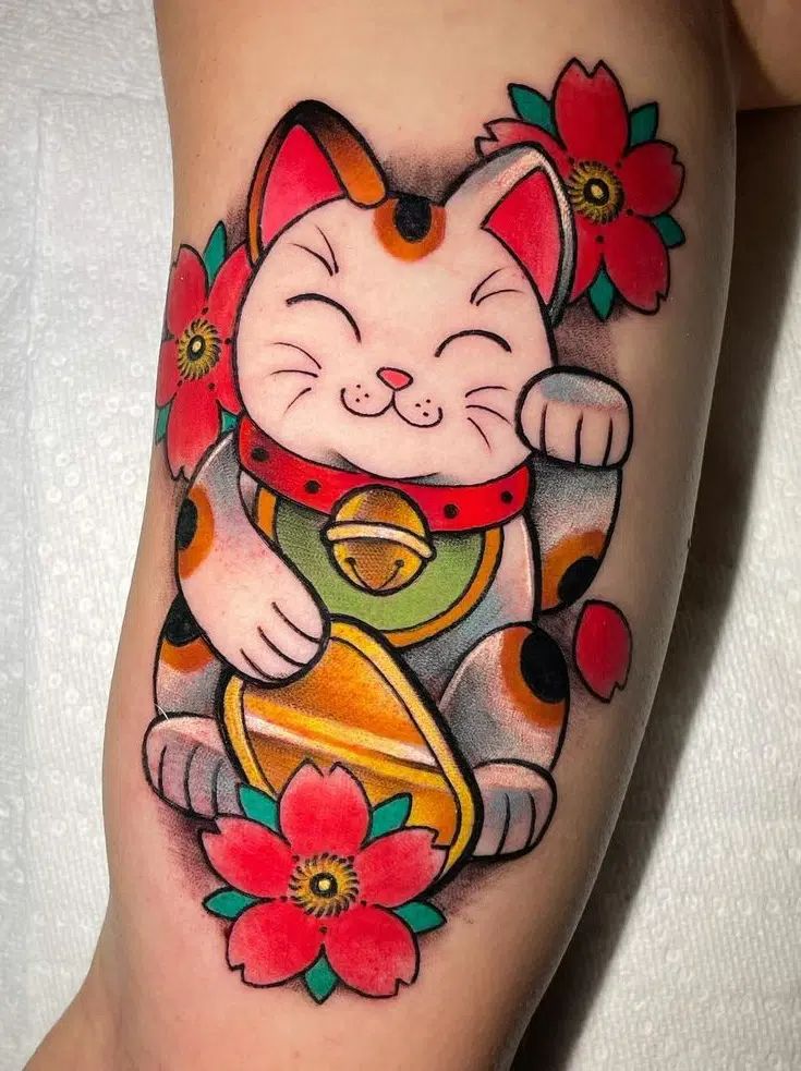 a cat with flowers on its leg is holding a gold bell in it's paws