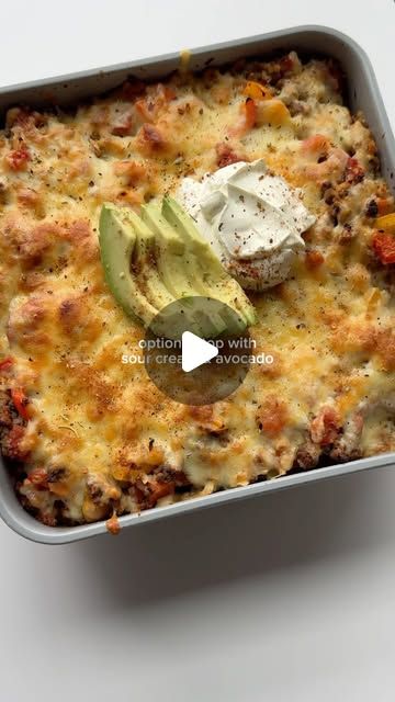 a casserole dish with meat, cheese and avocado