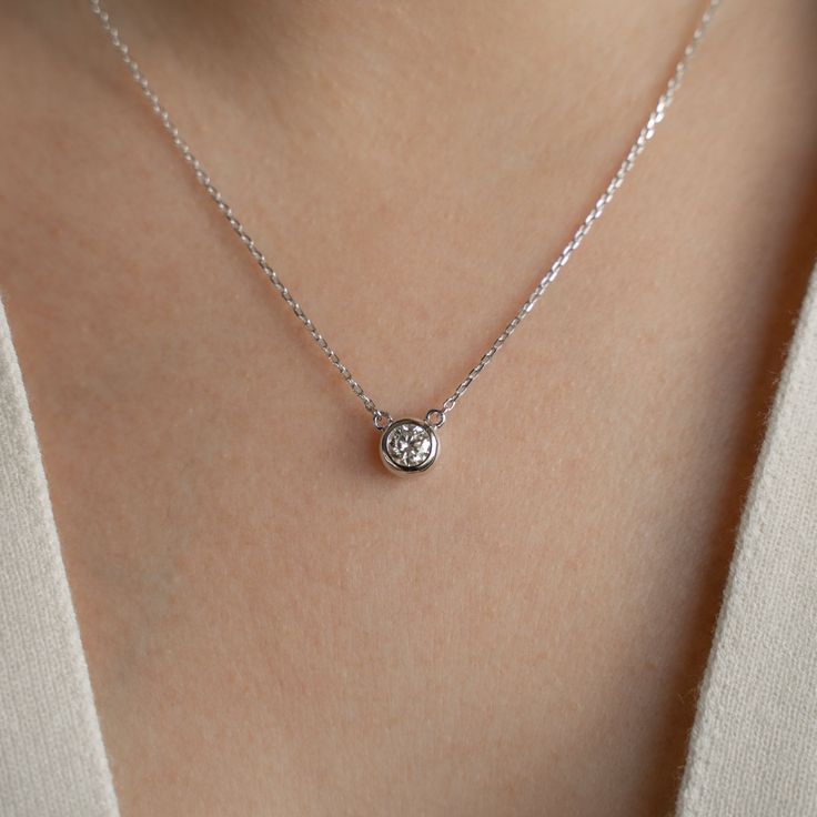 "Bring elegance to your daily look with our Round Cut Moissanite Pendant Necklace. This classic design, crafted in  14k white gold plating on sterling silver, offers timeless beauty for daily wear. The perfect gift for any occasion, this necklace is a symbol of enduring love and sophistication. ~ DESIGN ~ Metal: 14k White Gold Plating on Sterling Silver  Stone Weight: 5mm-0.5 carat Stone Color Grade: D Color Length of Chain: 16\" with 2\" extension Stone Shape: Round Cut Clarity Grade: VVS1 Cut Formal Classic Birthstone Necklace With Diamond Accents, 14k White Gold Solitaire Necklace With Brilliant Cut, Classic Formal Birthstone Necklace With Brilliant Cut, 14k White Gold Solitaire Necklace With Diamond Cut, Everyday Silver Diamond Necklace Round Cut, Everyday Silver Diamond Necklace With Vvs Clarity, Classic Sterling Silver Birthstone Necklace With Ethically Sourced Diamonds, Classic Silver Diamond Necklace For Everyday, Everyday Sterling Silver Diamond Necklace Vvs Clarity