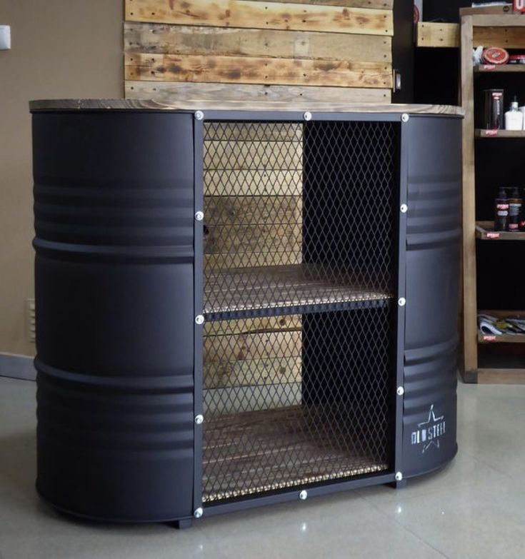 a large metal container sitting on top of a floor next to shelves filled with bottles