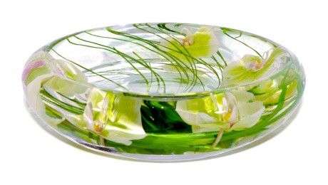 a glass bowl filled with water and flowers