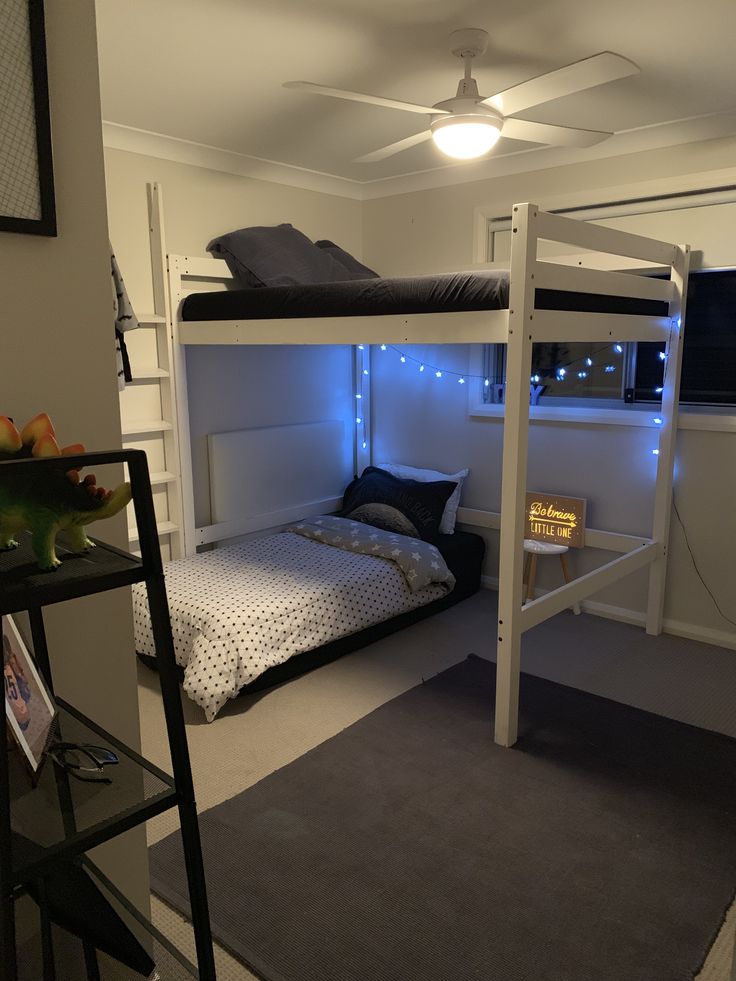 a bunk bed in a room with lights on the ceiling and carpeted flooring