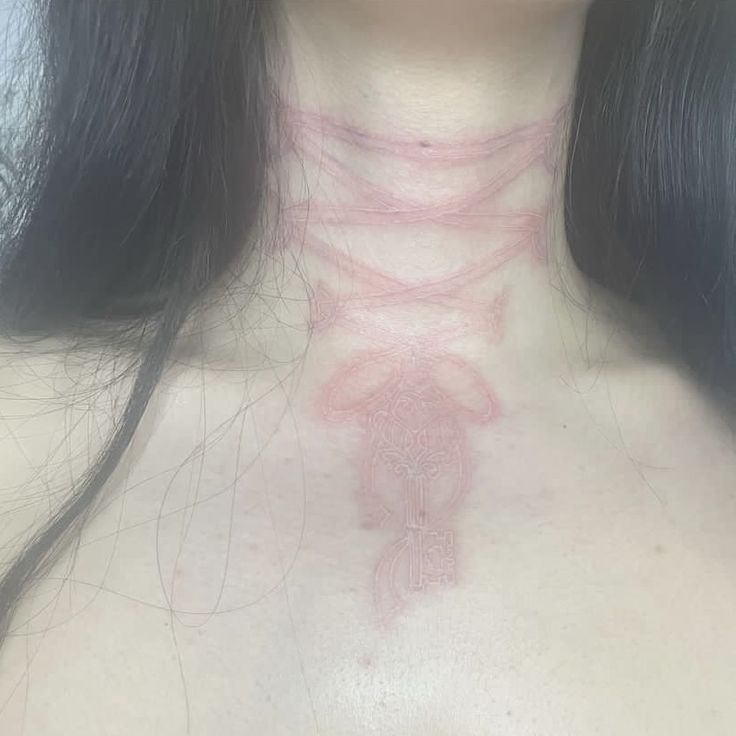 a woman's chest is shown with pink lines on the top of her chest