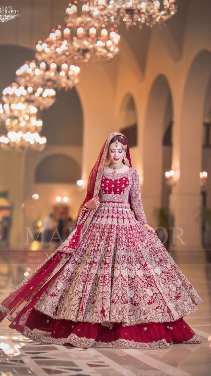 a woman in a red and white bridal gown