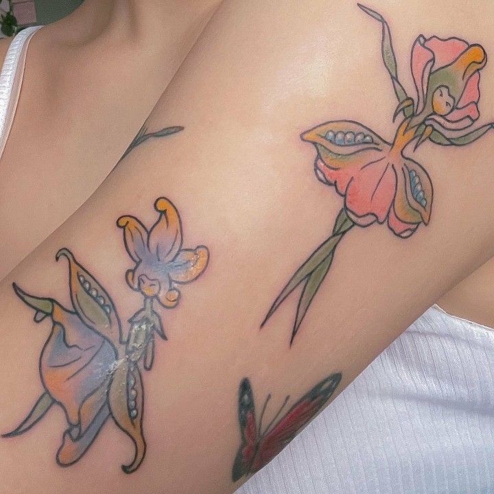 a woman's breast with two flowers on her left side and one flower on the right