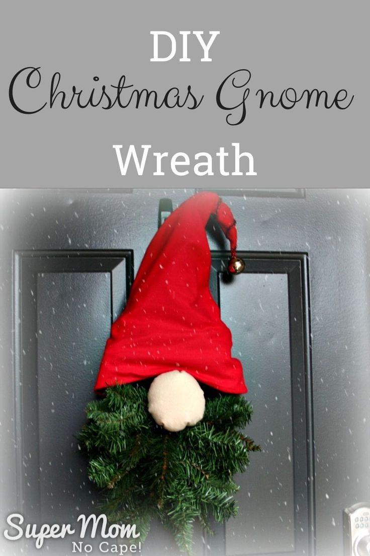 a christmas wreath with the words diy christmas gnome wreath on it and an elf's hat