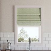 a kitchen sink under a window next to a faucet mounted on a wall