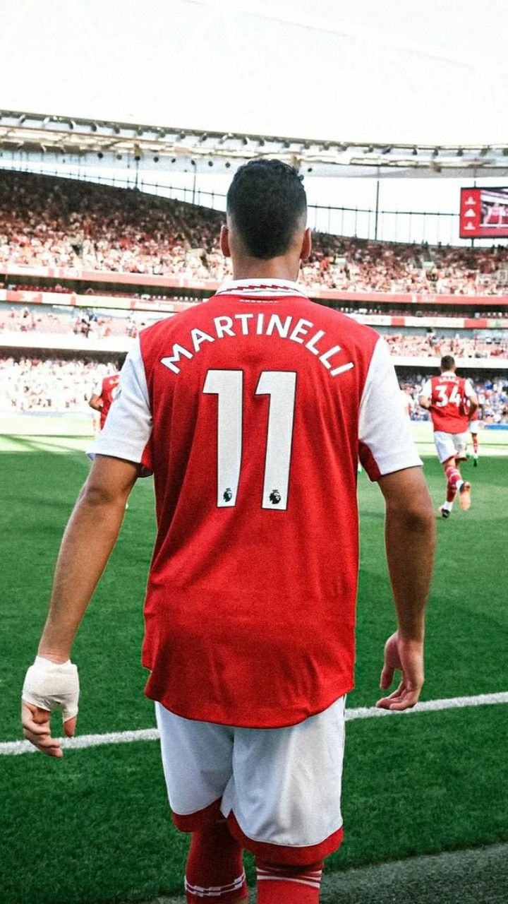 the back of a soccer player's jersey at a stadium with fans in the stands