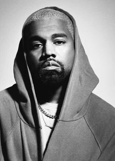 a black and white photo of a man wearing a hoodie