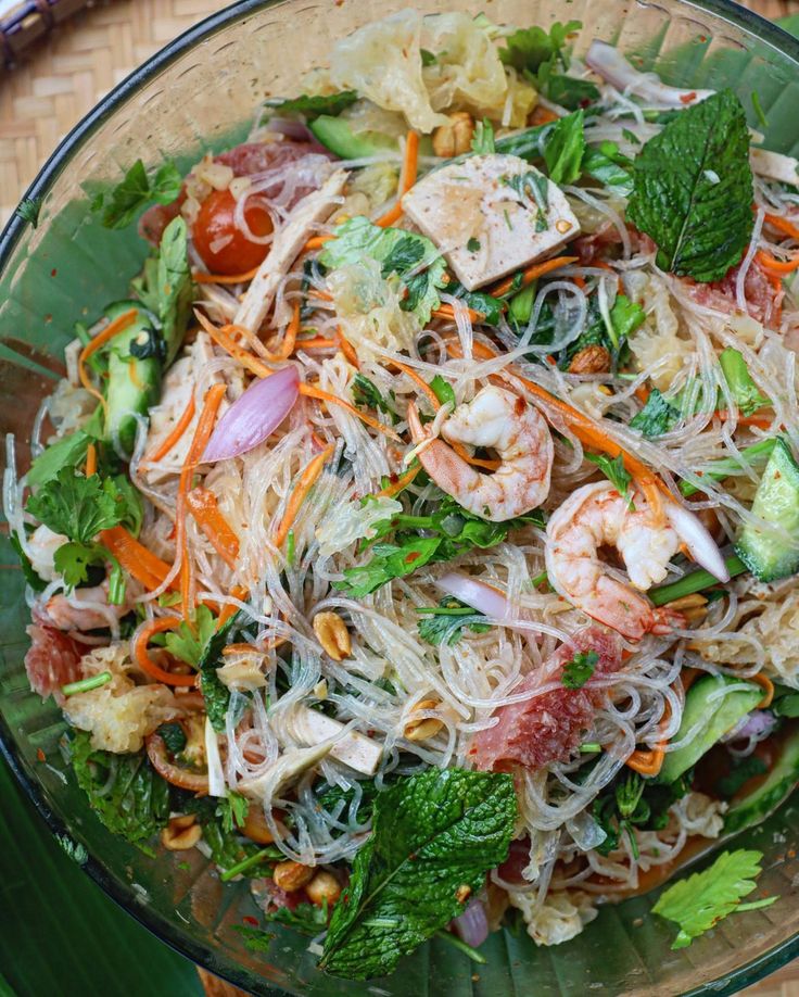 a glass bowl filled with food on top of a table