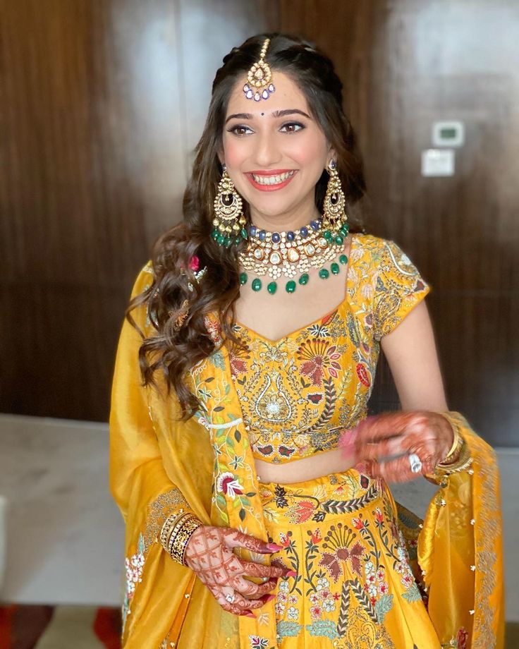 a woman in a yellow outfit and jewelry