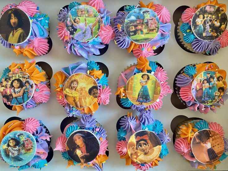 there are many cupcakes decorated with pictures on the top one is princesses