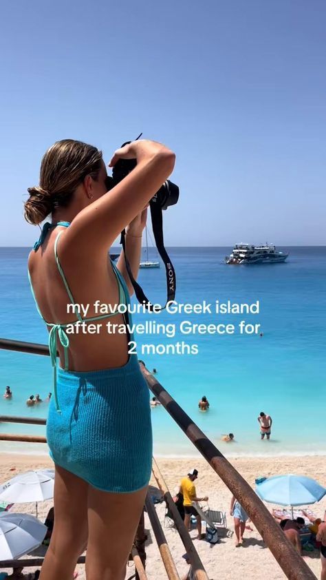 a woman in a blue bathing suit is taking pictures on the beach with her camera