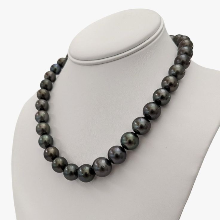 Adorn your neck with the sheer opulence of this stunning Tahitian Pearls necklace. Intricately designed, it promises to add a dash of luxury and sophistication to any ensemble. The necklace comprises a series of Tahitian pearls, varying in size from 11 to 14.5 mm, culminating in a radiant and lustrous display of elegance. Deep and rich, the aubergine hue of the pearls projects a sense of refinement. The uniform color profile across the pearls leads to a harmonious and cohesive visual appeal, res Black Tahitian Pearl Necklaces With Round Beads, Black Tahitian Pearl Necklace With Round Beads, Luxury Tahitian Pearl Single Strand Necklace, Luxury Black Tahitian Pearl Necklaces, Luxury Black Pearl Necklace With Round Beads, Tahitian Pearl Necklace, Color Profile, Tahitian Pearls, Out Of Style