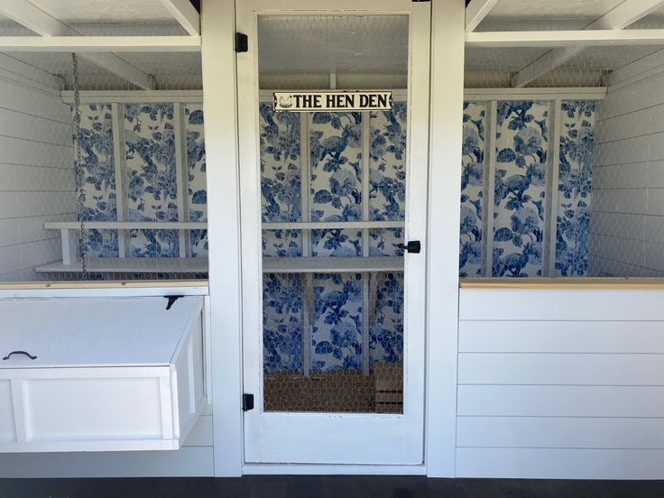 an open door to a room with blue and white wallpaper on the outside walls