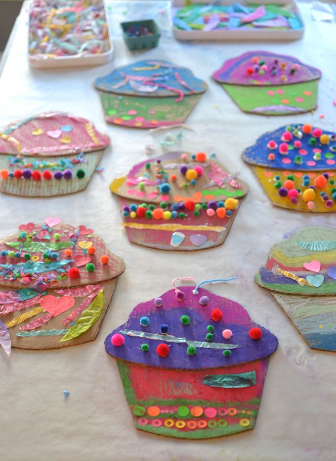 many decorated cupcakes on a table with sprinkles