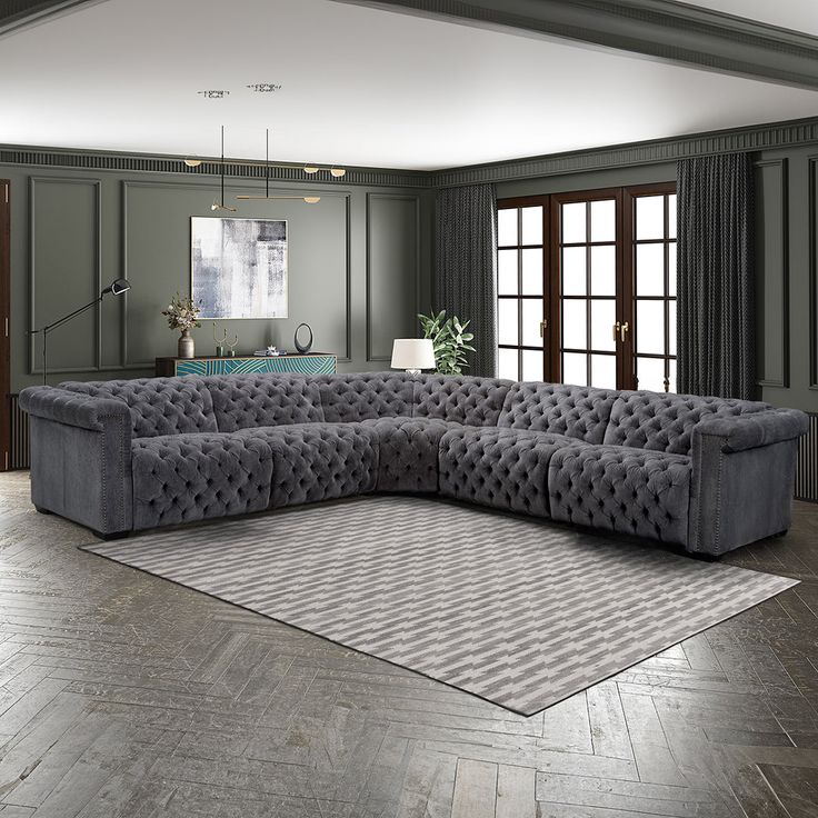 a large gray couch sitting in the middle of a living room