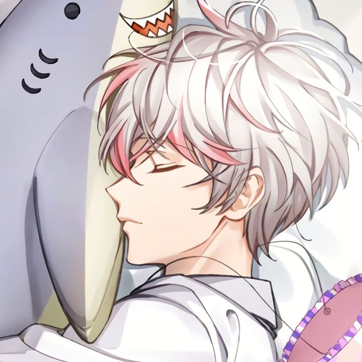 a man laying in bed next to a shark with his head on top of a pillow