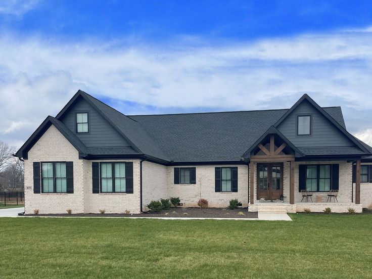 a white house with black roof and windows