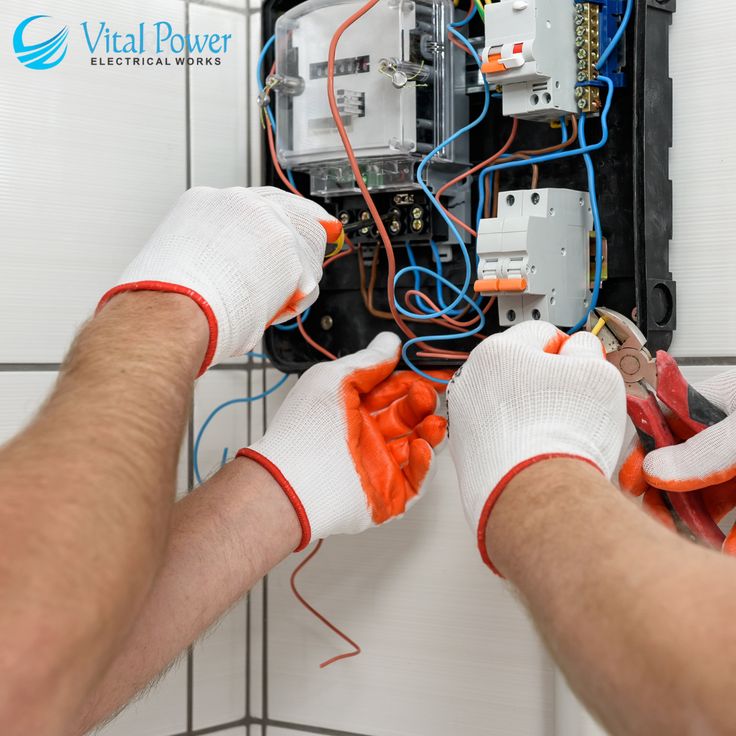 a man is working on an electrical panel