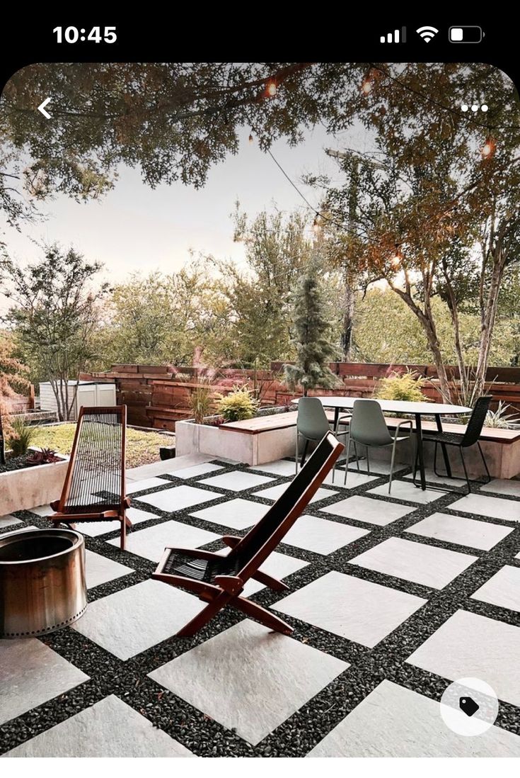 an outdoor patio with chairs, table and fire pit