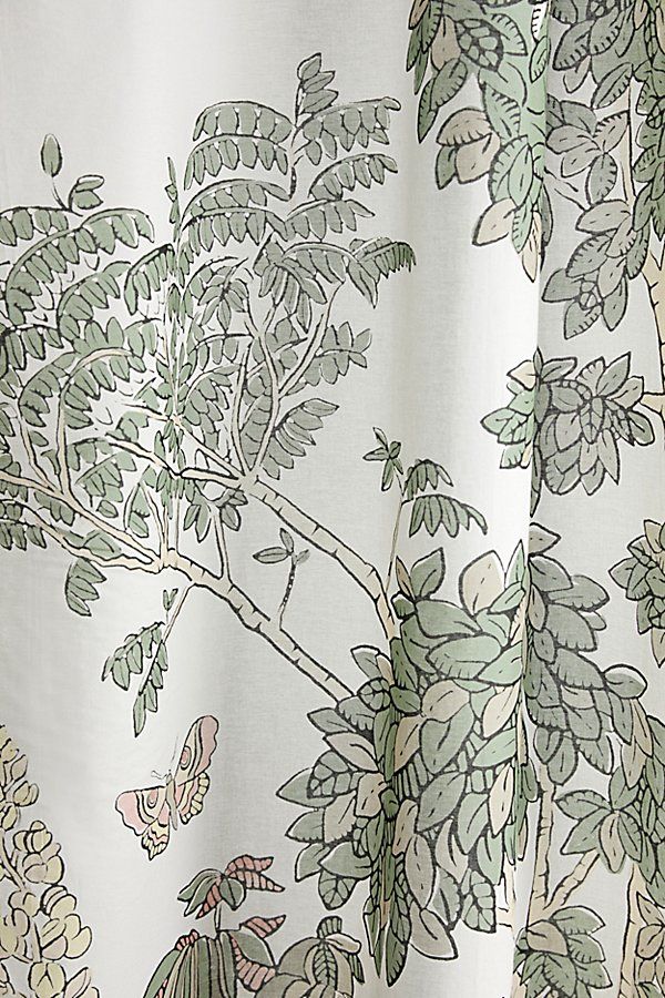 the curtain is decorated with green and white flowers, leaves and birds on it's side