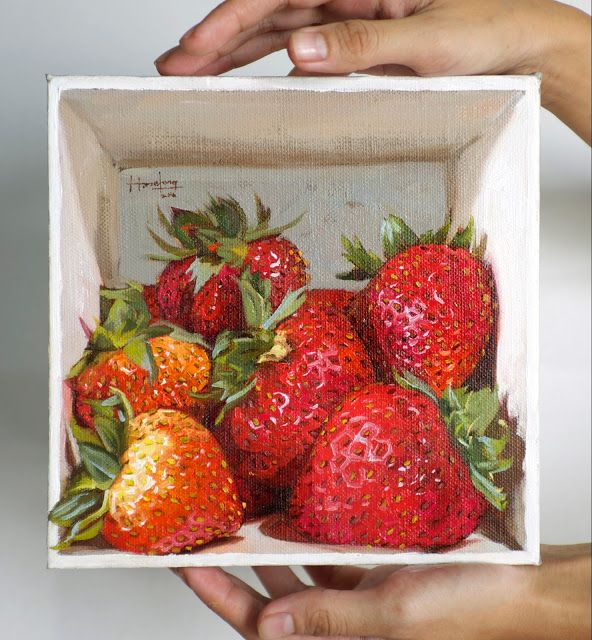 a painting of strawberries in a box being held by two hands