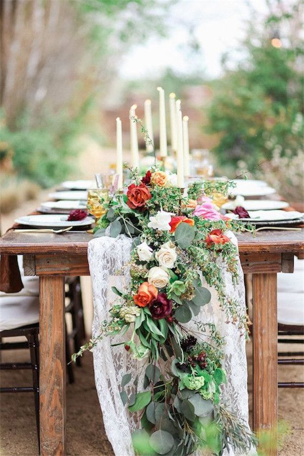 a table with flowers and candles on it