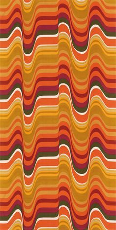 an orange and green striped rug with wavy lines on the bottom, in different colors