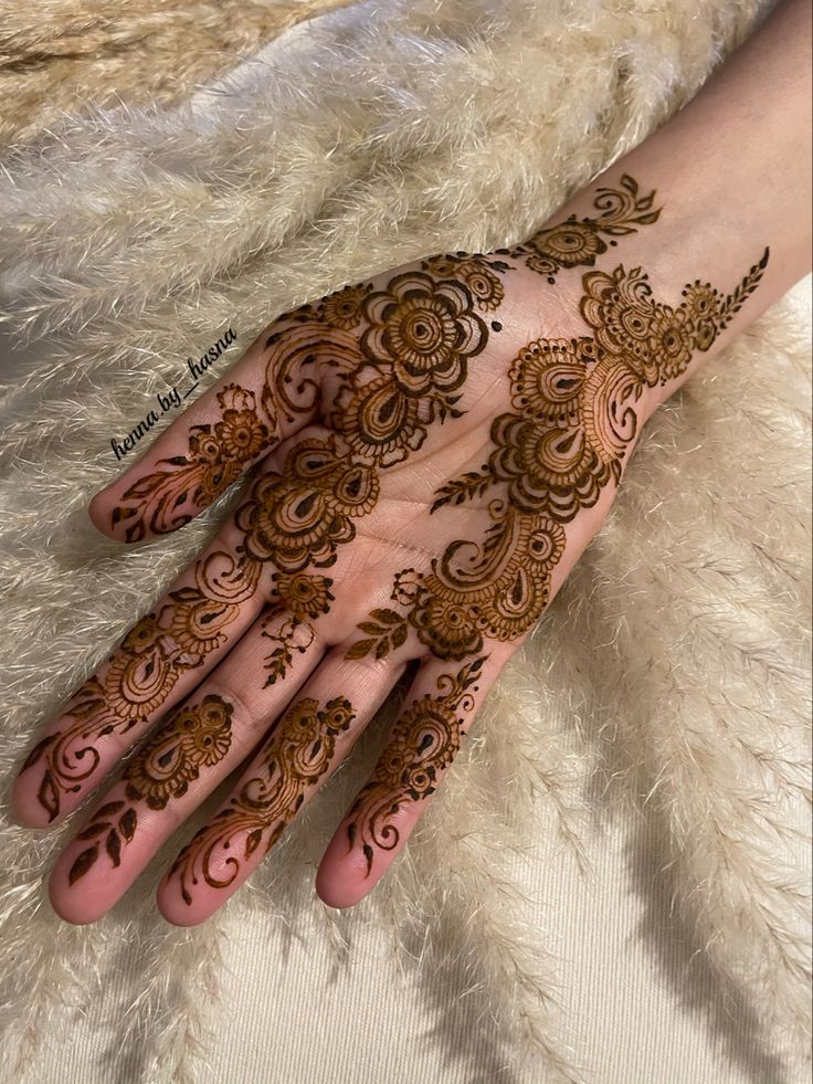 henna tattoo on the palm of someone's hand