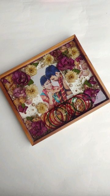 an art piece with flowers and rings on it