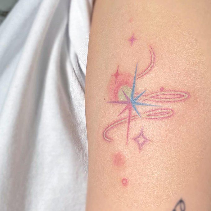 a woman's arm with a tattoo on it that has a star in the center