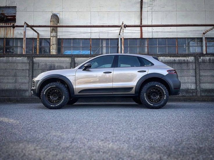 a silver suv parked in front of a building