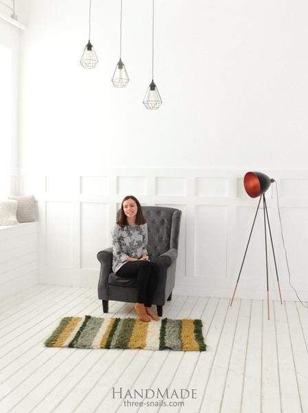 a woman sitting on a chair in a white room