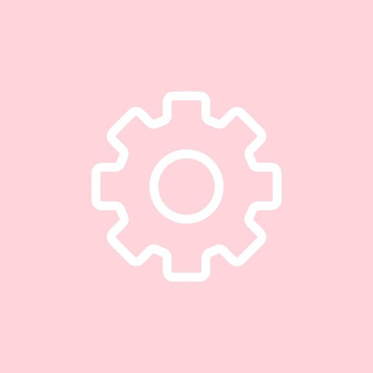 a white gear wheel on a pink background