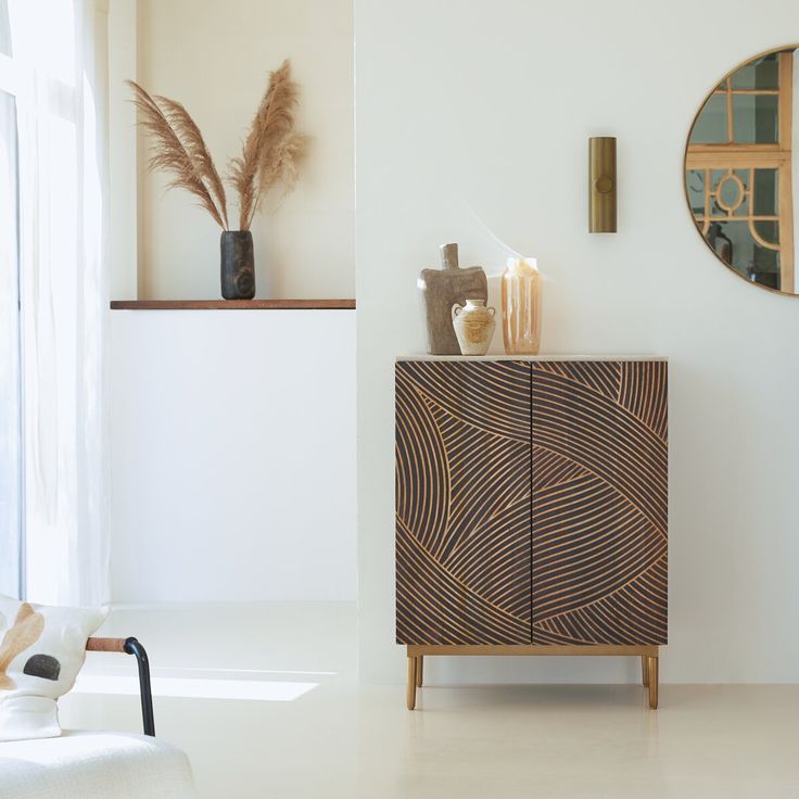 a white room with a wooden cabinet and mirror