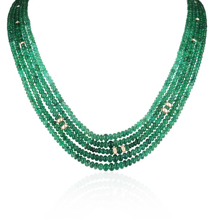 A beautiful multi-strand emerald bead necklace. This simple and stylish necklace features five strands of polished rondelle emerald beads. This necklace measures 22 inches long. The draping of this necklace allows you to see the gorgeous green color of the polished emerald rondelle beads. The beads in this necklace are graduated and get smaller towards the golden 14K clasp. Setting Style: Five Strands Setting Material: 14K Yellow Gold Main Stone: Emerald Shape: Rondelles Approx Weight: 294+ Carats (Total) Treatment: Natural Origin: Zambia A certificate of appraisal is provided upon purchase. Keep in mind we custom create all of the items listed here. If you have a special request for a custom-created item please contact us at 1 800 840 6828. Complimentary shipping within the USA. Elegant Polished Emerald Bead Necklace For Formal Occasions, Elegant Polished Emerald Beads Necklace For Formal Occasions, Elegant Emerald Beaded Necklaces, Elegant Emerald Jewelry With Polished Beads, Elegant Emerald Necklace With Round Beads, Elegant Formal Emerald Necklace With Faceted Beads, Elegant Rondelle Emerald Necklace, Elegant Emerald Briolette Necklace With Gemstone Beads, Elegant Beaded Emerald Necklaces