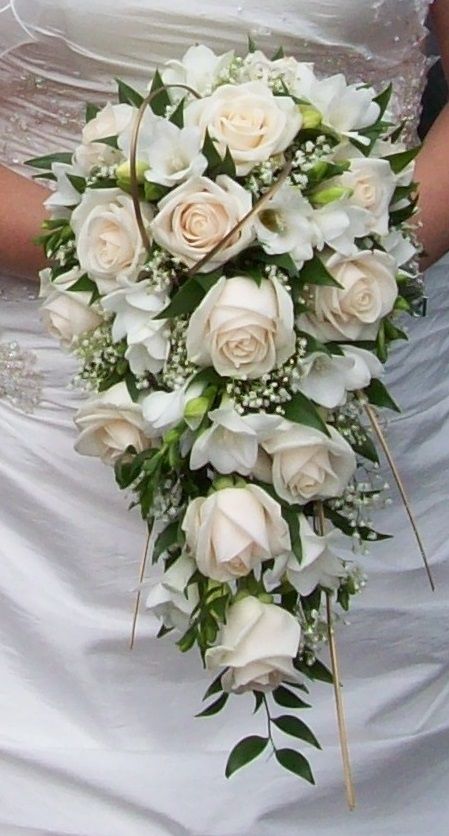 a bridal bouquet with white roses and greenery