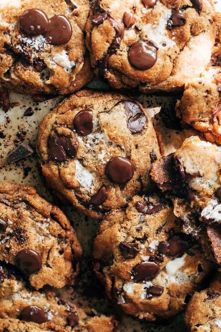 chocolate chip cookies with marshmallows and chocolate chips are piled on top of each other