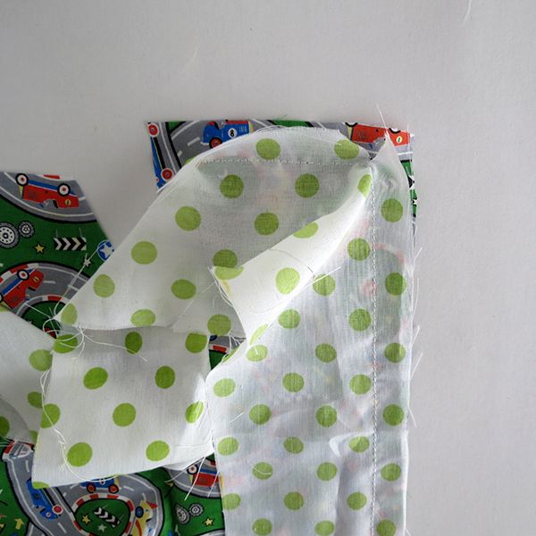 there is a green and white polka dot cloth on top of the other fabric material